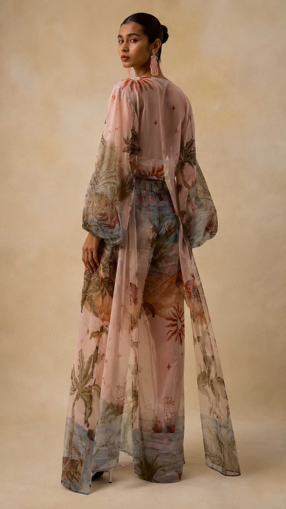 Back view of blush pink printed three-piece set with flowing long sheer overlay