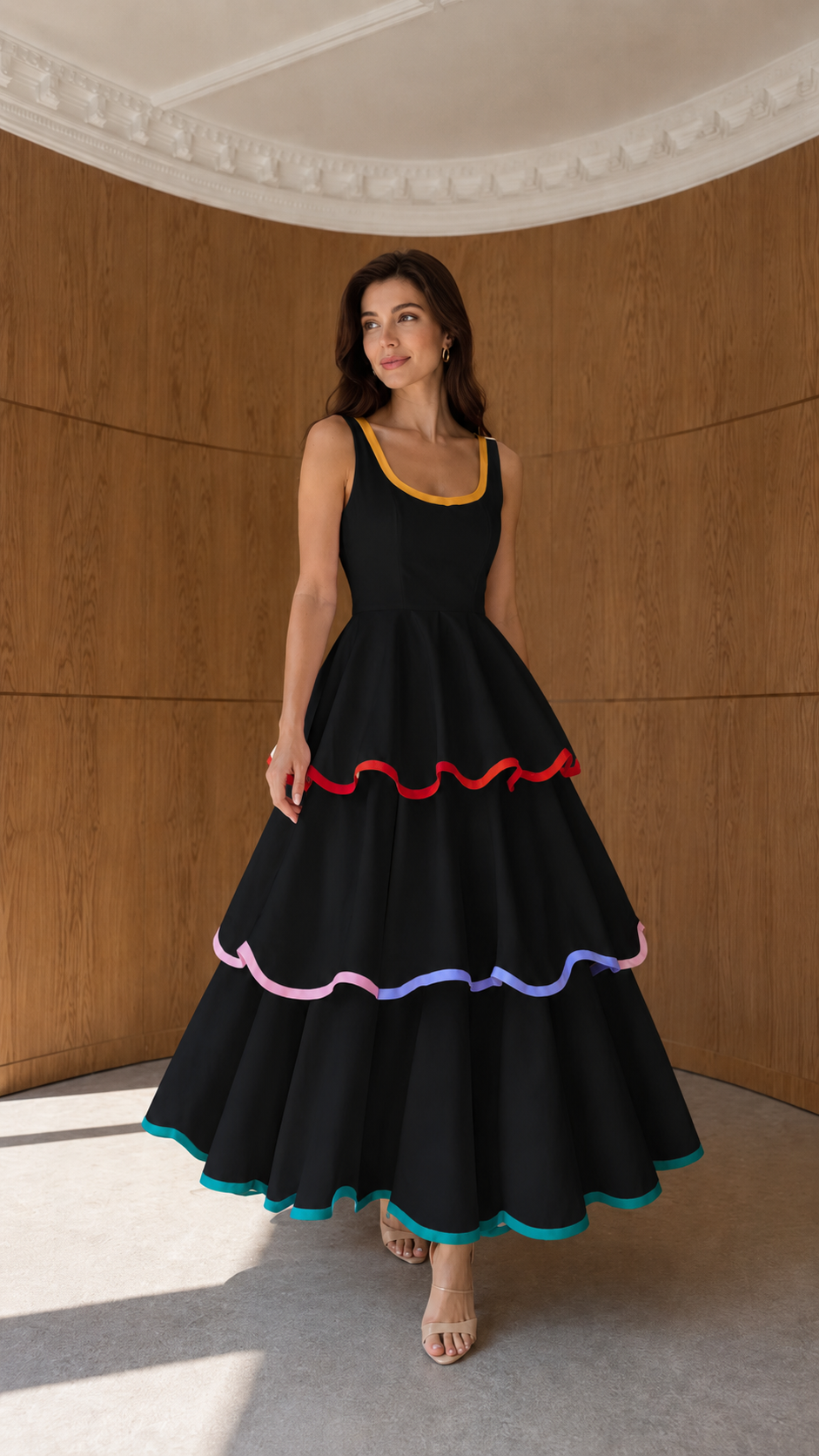Front view of black tiered sleeveless maxi dress with colorful trim