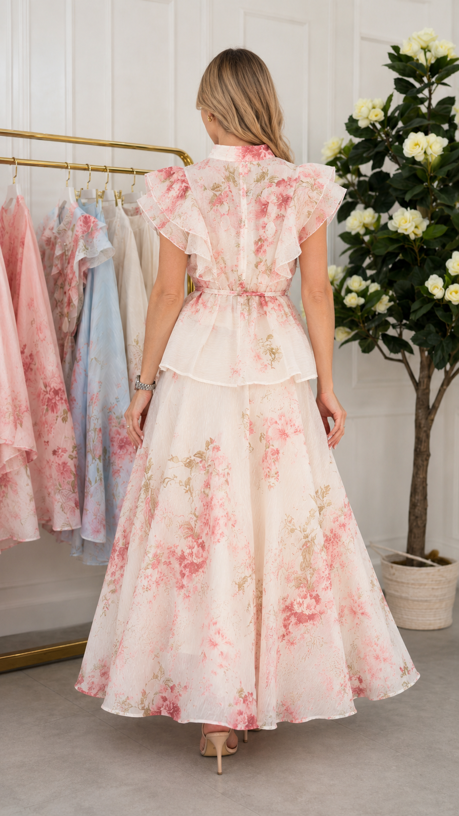 Back view of ivory floral maxi dress with flutter sleeves and gathered waist