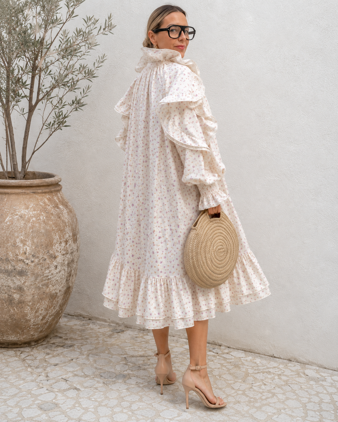Back view of cream floral midi dress with ruffle hem and voluminous sleeves