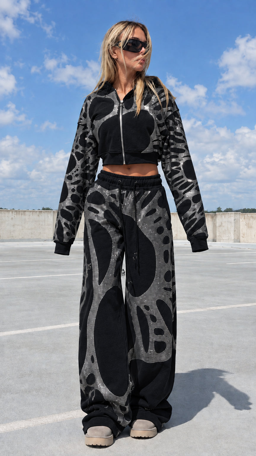 Model wearing black rhinestone cropped zip hoodie and wide leg sweatpants set