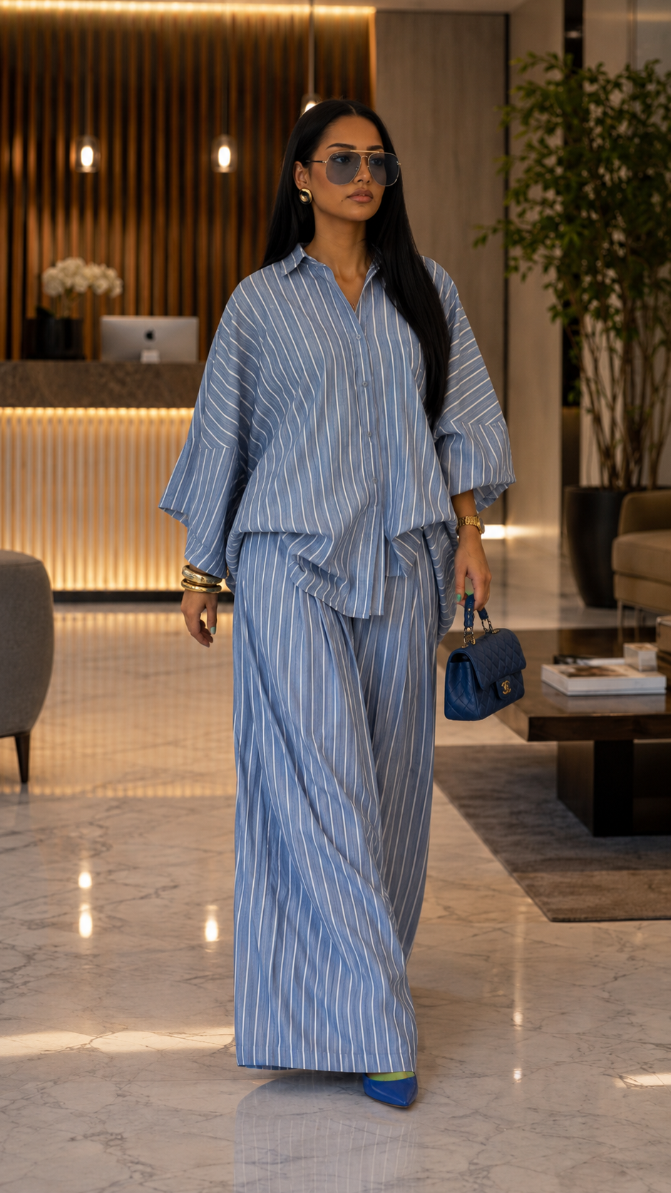 Front walking view of dusty blue striped matching set with wide leg pants