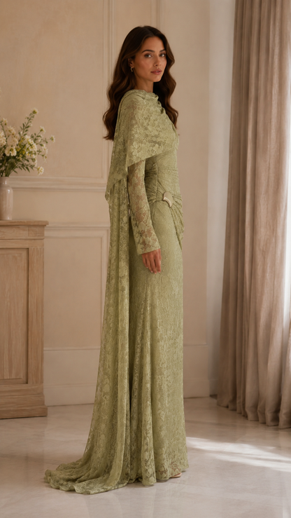 Side view of sage lace evening dress showing the flowing cape overlay and fitted silhouette
