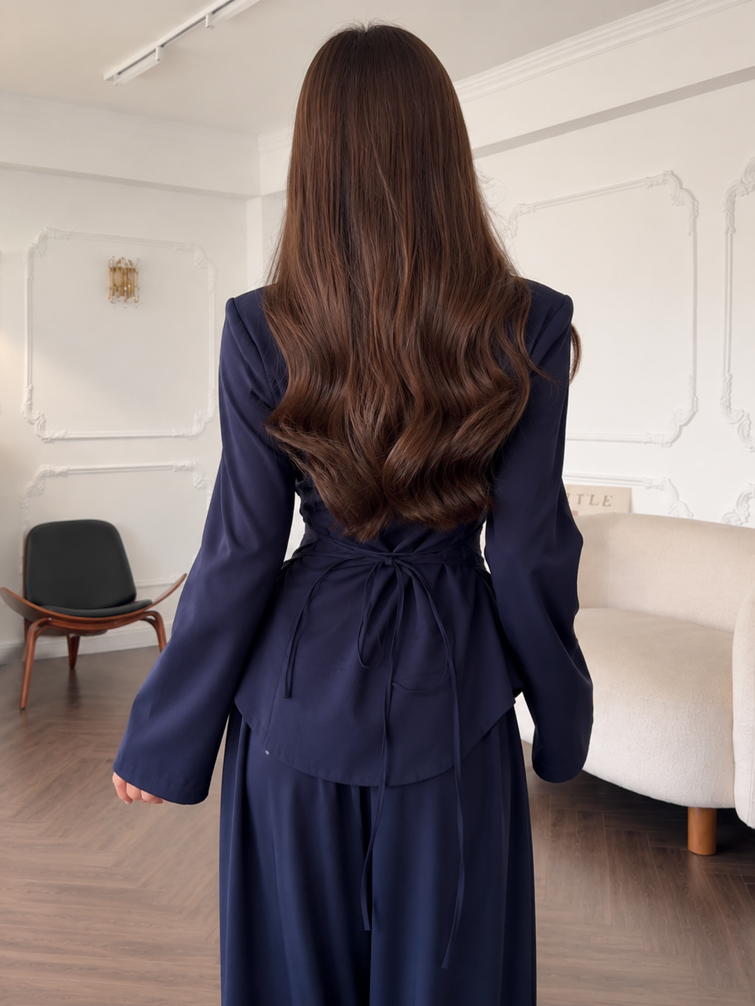 Back view of the navy fitted top with self-tie waist detail and matching pants