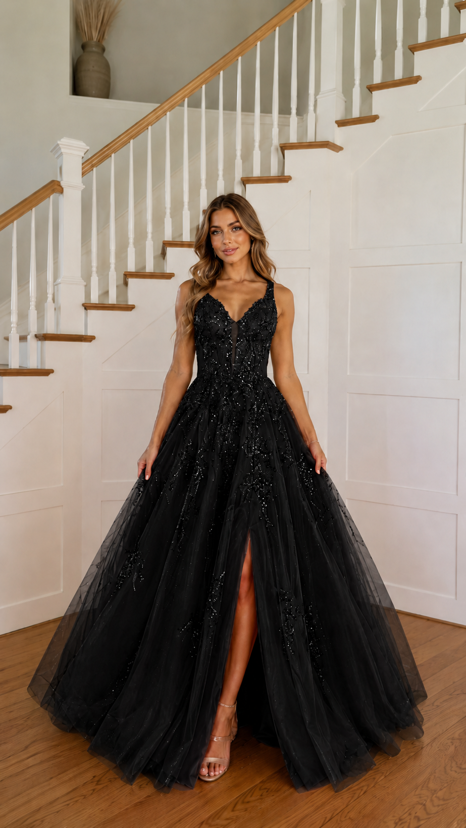 Front view of black embroidered tulle ball gown with high slit