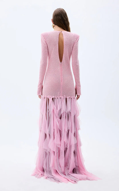 Back view of blush pink long-sleeve textured gown with open back and ruffle hem