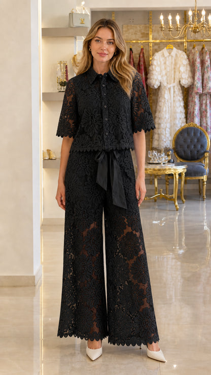 Model wearing black floral lace button-up top and wide-leg pants set