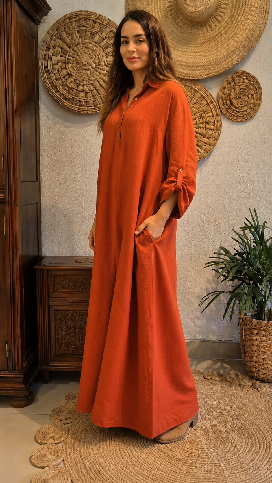 Side angled view of rust button-front maxi dress with relaxed drape