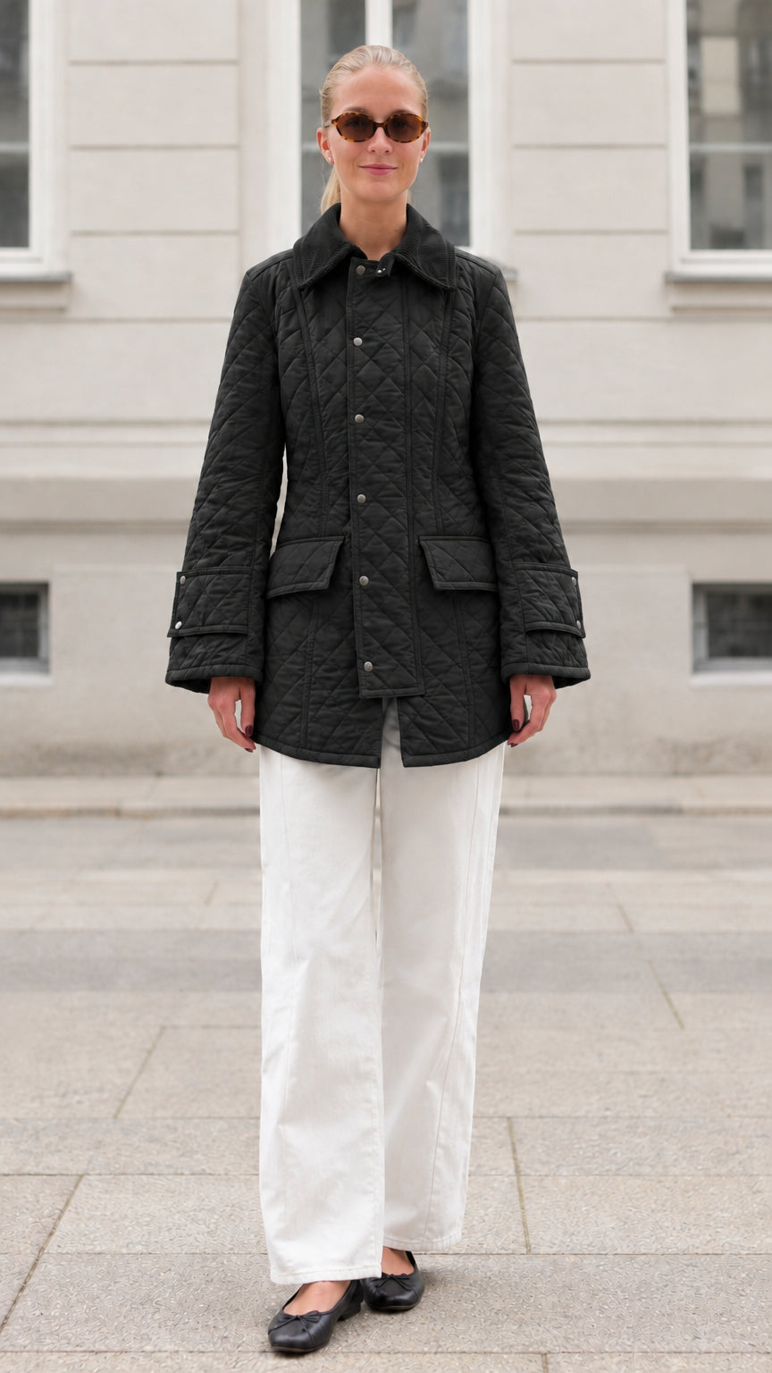Front full-length view of woman wearing black diamond quilted barn jacket