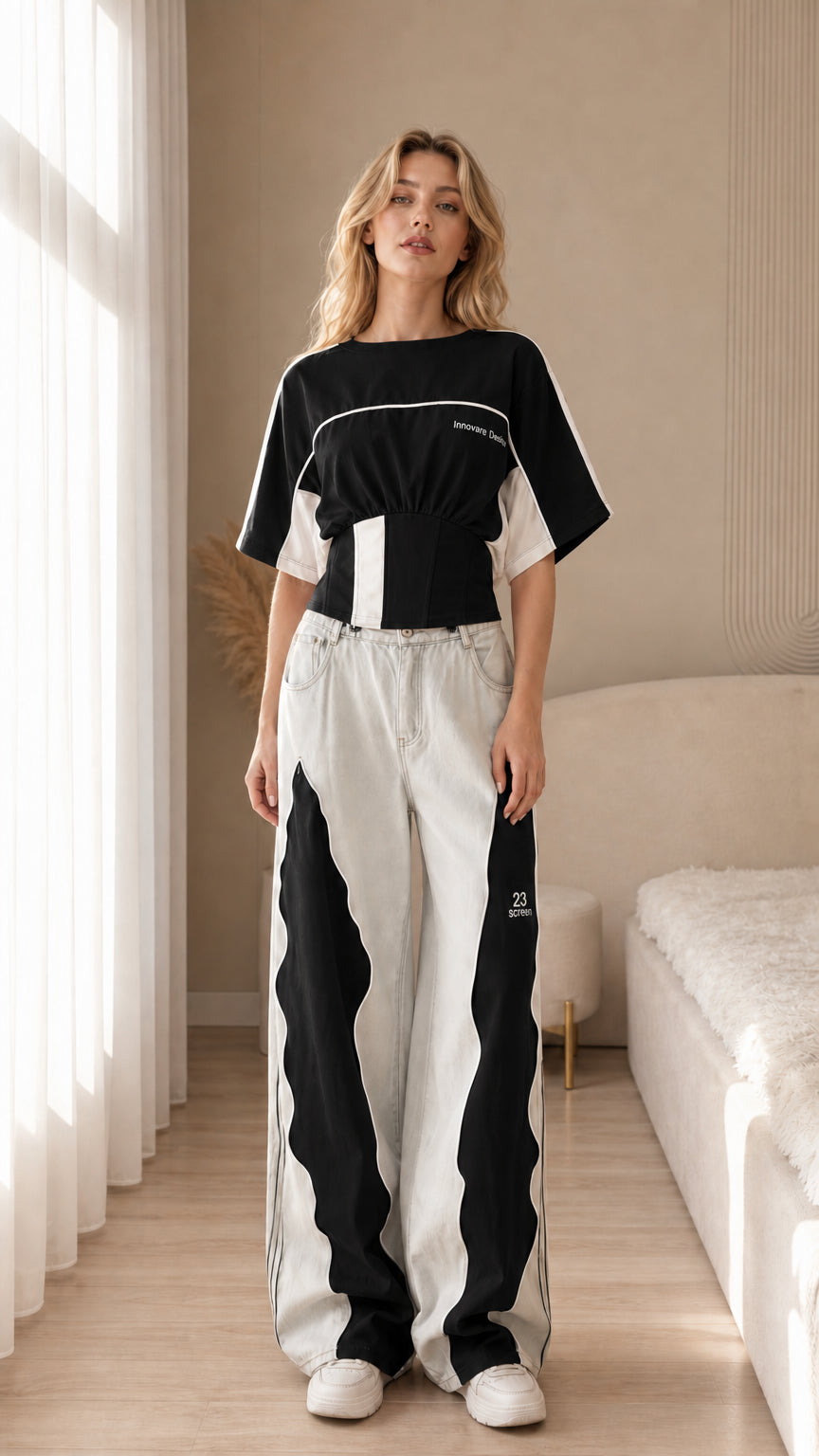 Front view of the black color block cropped sport top styled with light trousers