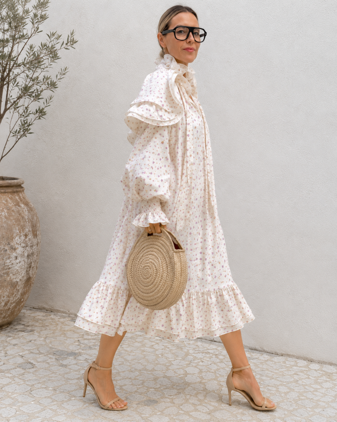 Side view of cream floral puff sleeve midi dress with flowing silhouette