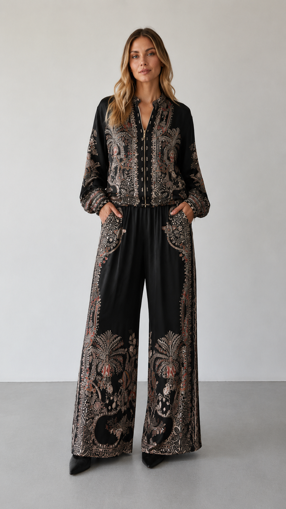 Front view of black paisley print matching set with zip-front top and full-length pants