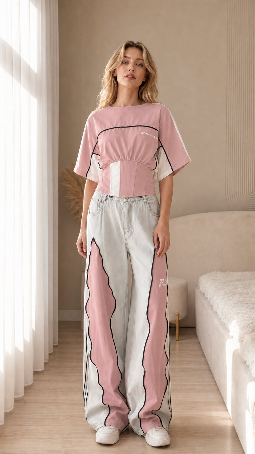 Front view of the pink color block cropped sport top styled with light trousers