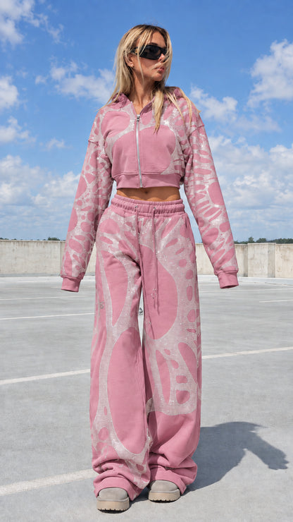 Model wearing pink rhinestone graphic cropped hoodie and sweatpants tracksuit