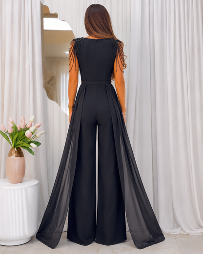 Back view of black sleeveless jumpsuit with shoulder strand detail