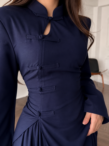 Close-up detail of the mandarin-style neckline, keyhole opening, and front knot accents