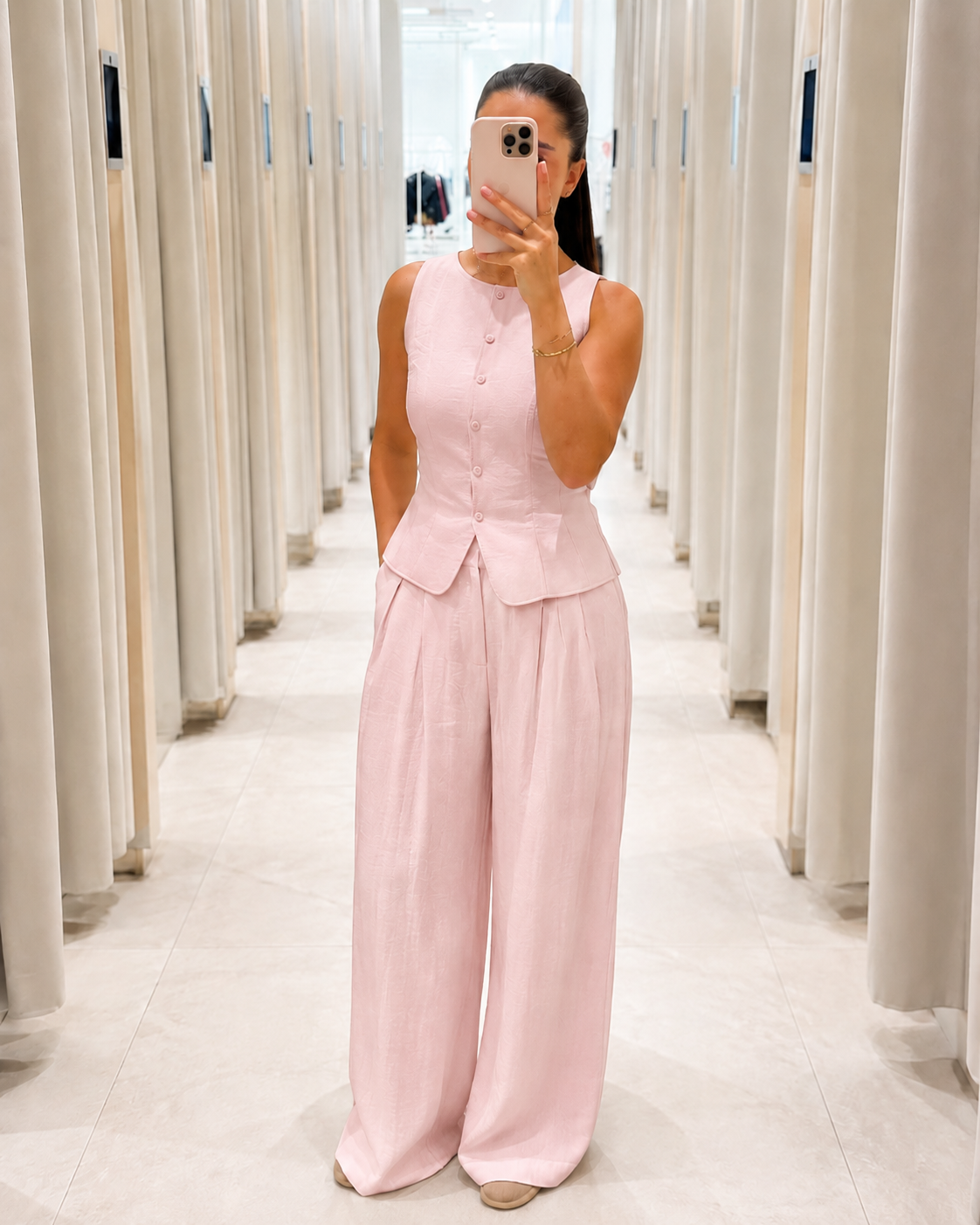 Front view of blush pink sleeveless peplum top and wide leg pants set