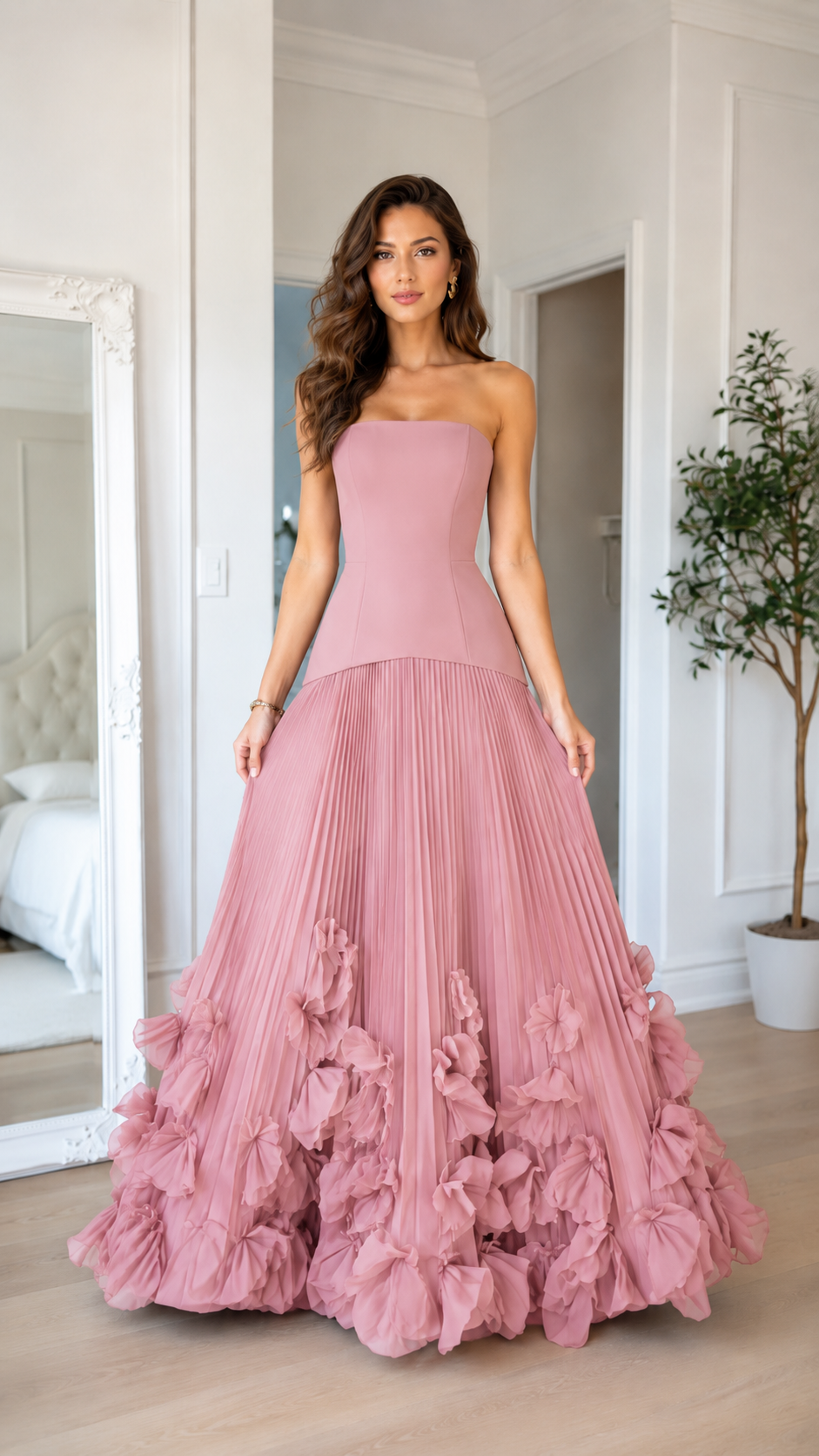 Front view of blush pink strapless maxi gown with pleated skirt and ruffle hem