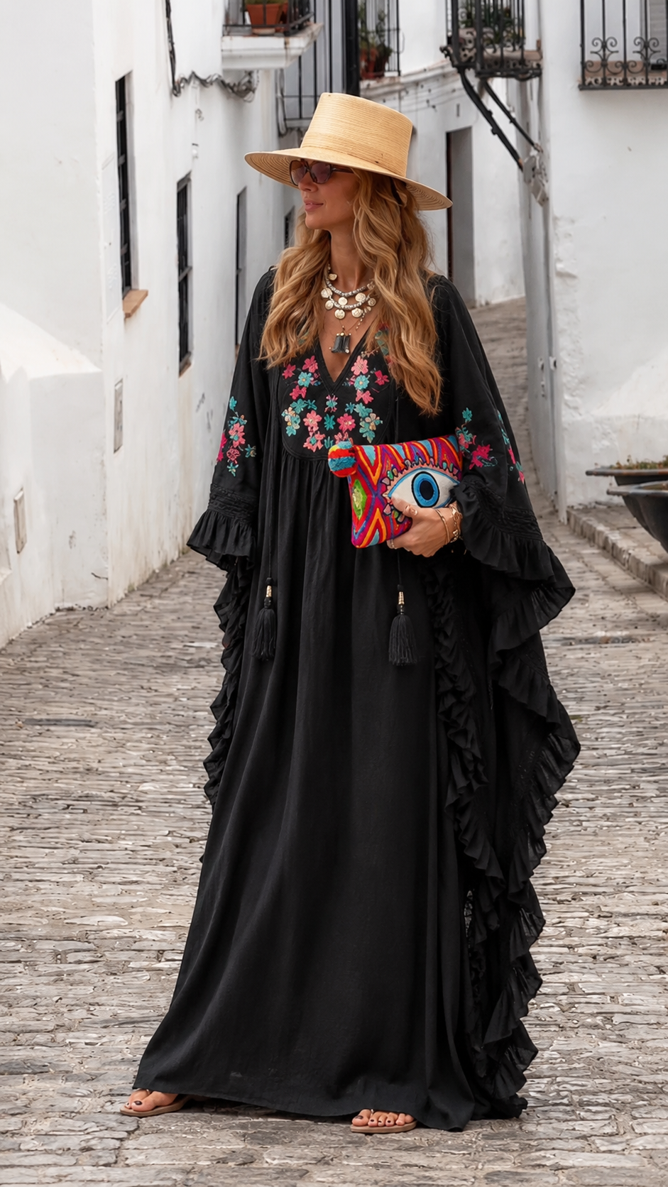 Black embroidered caftan maxi dress with colorful floral detail and dramatic drape