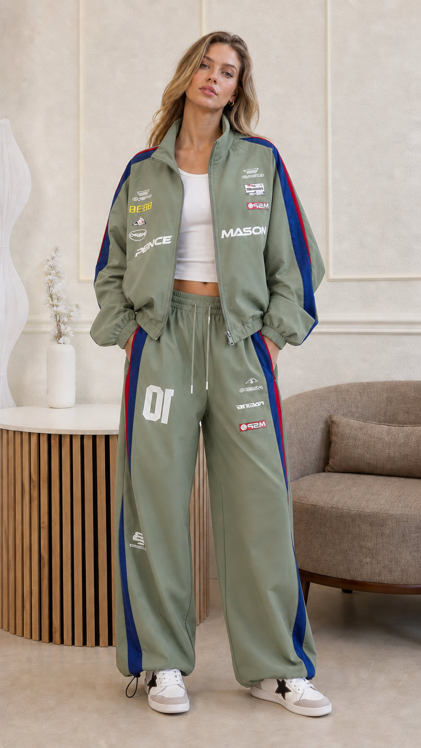 Full front view of woman wearing sage green vintage racing jacket and track pants set