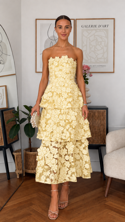 Front view of butter yellow strapless 3D floral tiered midi dress