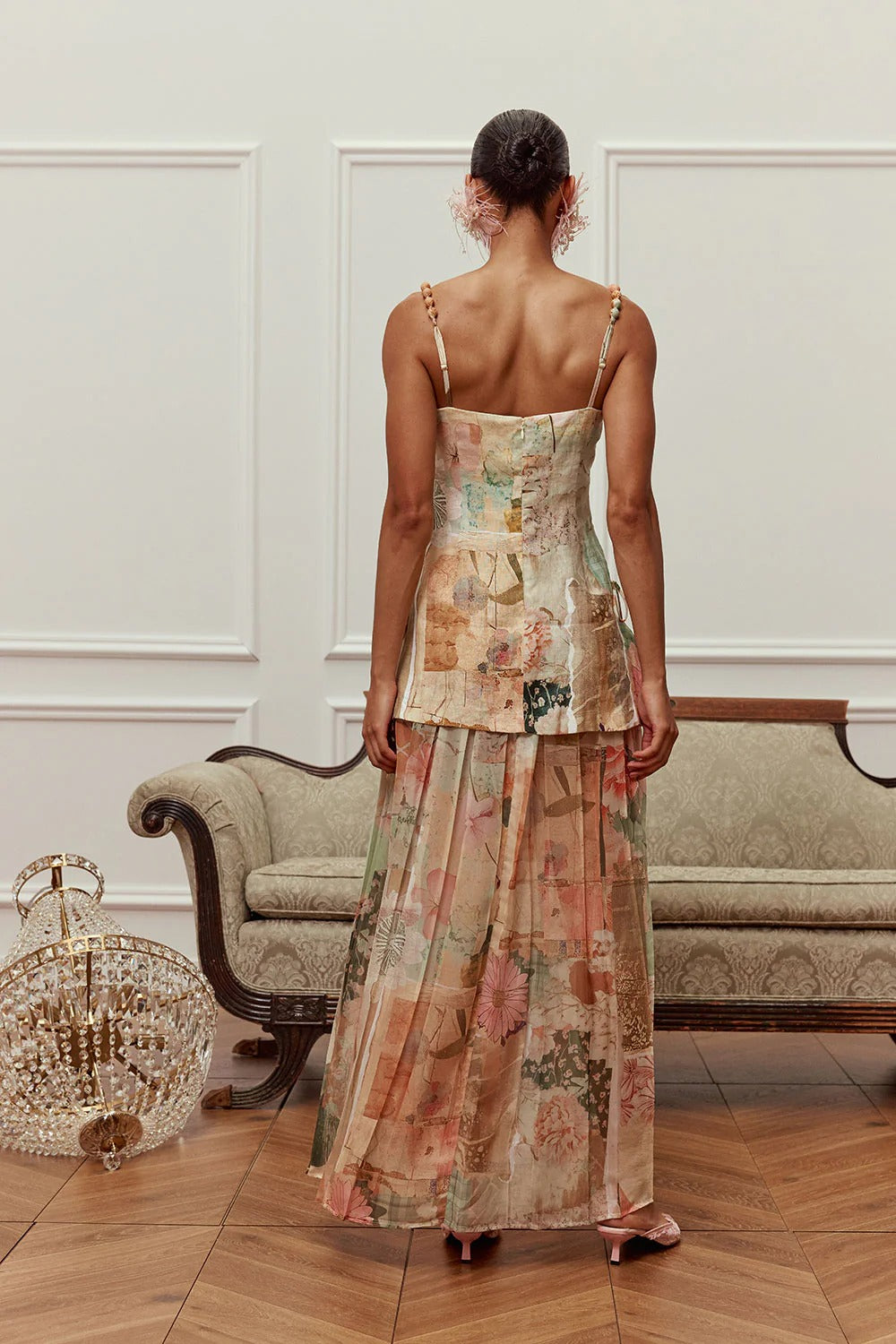 Back view of the pastel floral maxi dress with slim straps and flowing full-length skirt