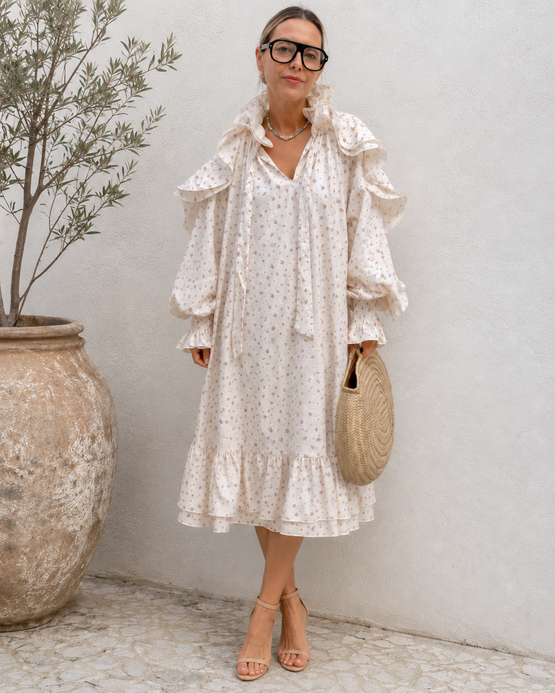 Full-length front view of cream floral ruffle detail midi dress