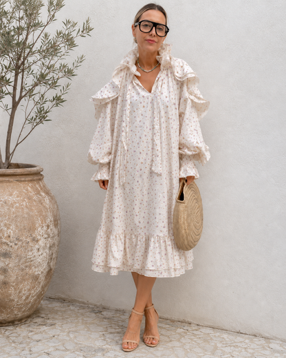 Full-length front view of cream floral ruffle detail midi dress