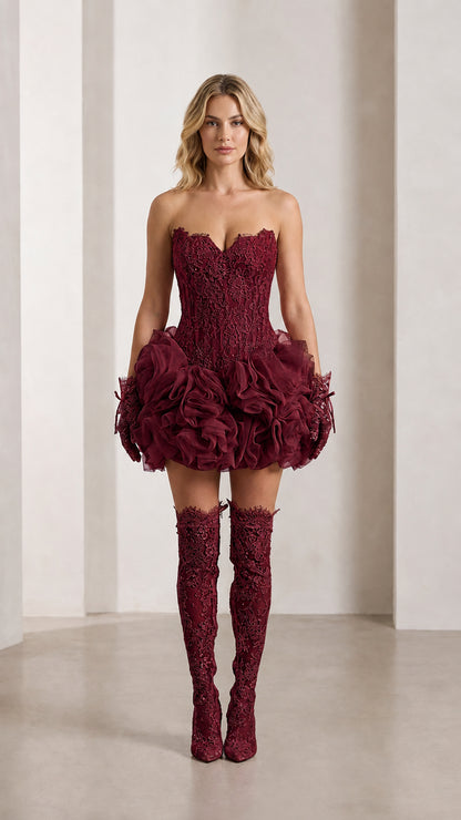 Model wearing burgundy wine red strapless lace corset mini dress with textured ruffle hem