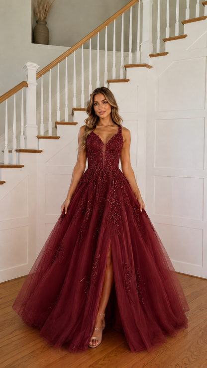 Front view of burgundy embroidered tulle ball gown with plunging neckline
