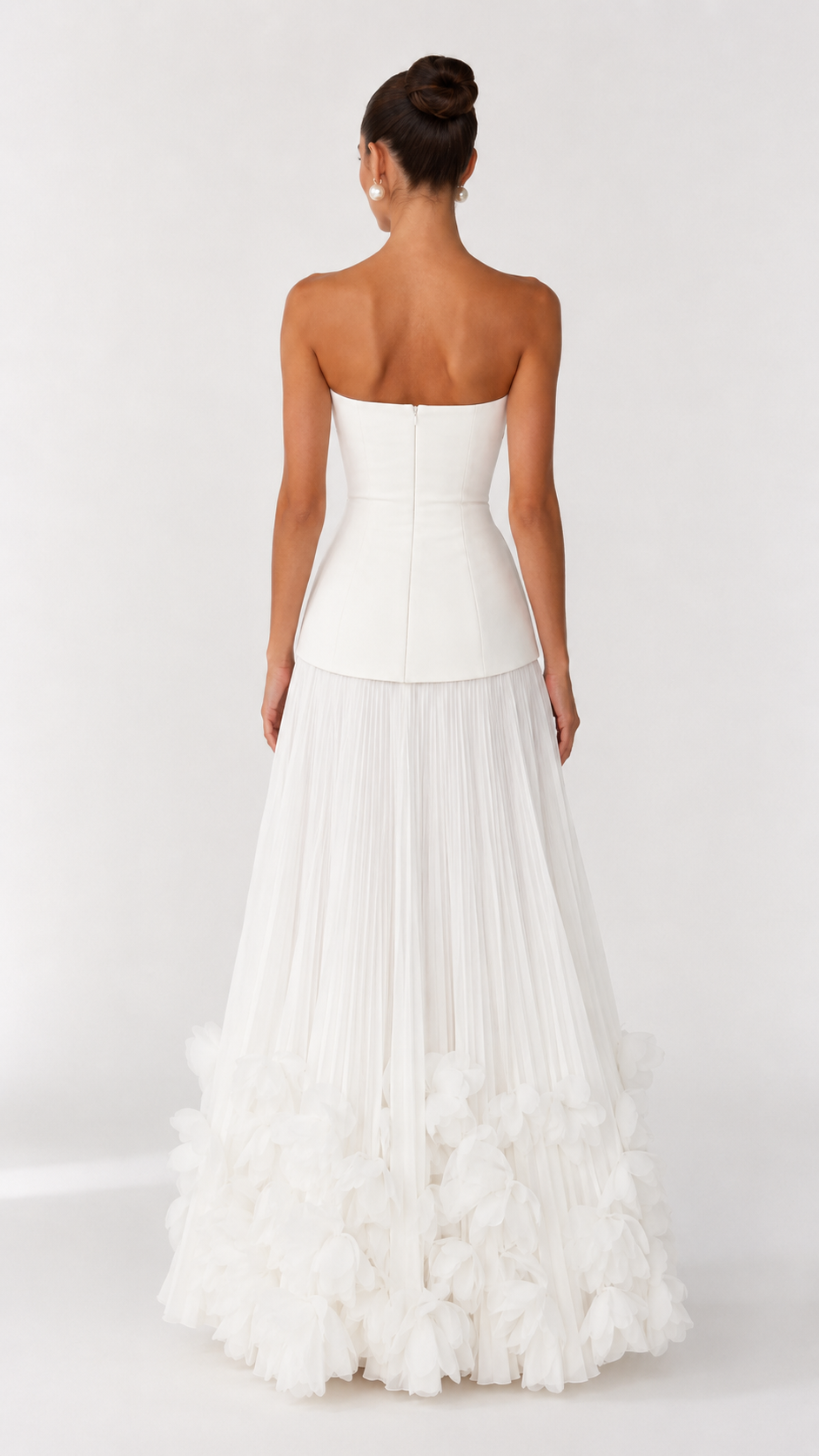 Back view of ivory strapless maxi dress with center back zipper and pleated skirt