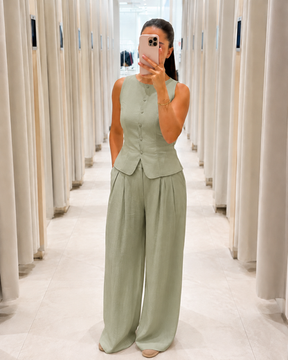 Front view of sage sleeveless peplum top and wide leg pants set