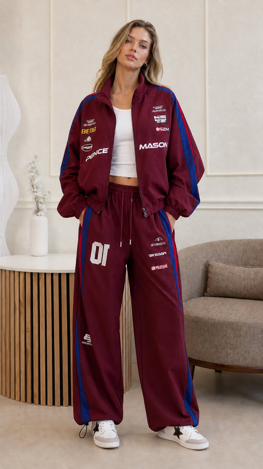 Full front view of woman wearing burgundy two-piece racing track suit