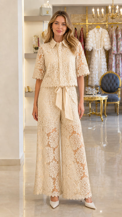 Model wearing champagne cream floral lace short-sleeve top and wide-leg trousers