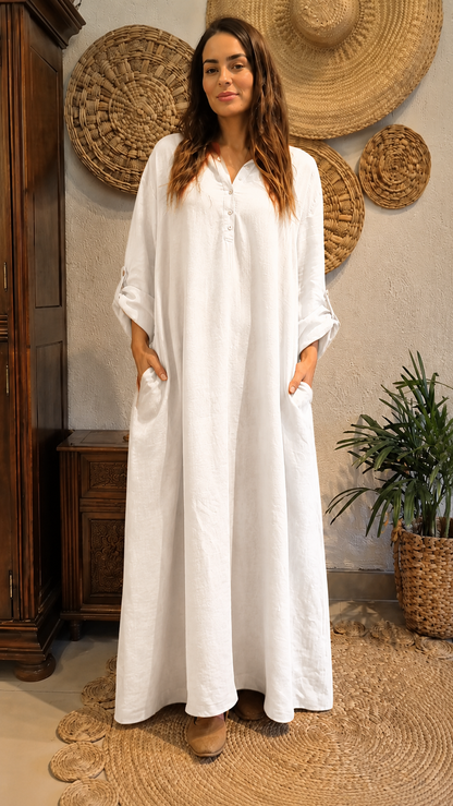 Front view of white flowing maxi dress with relaxed fit and long sleeves