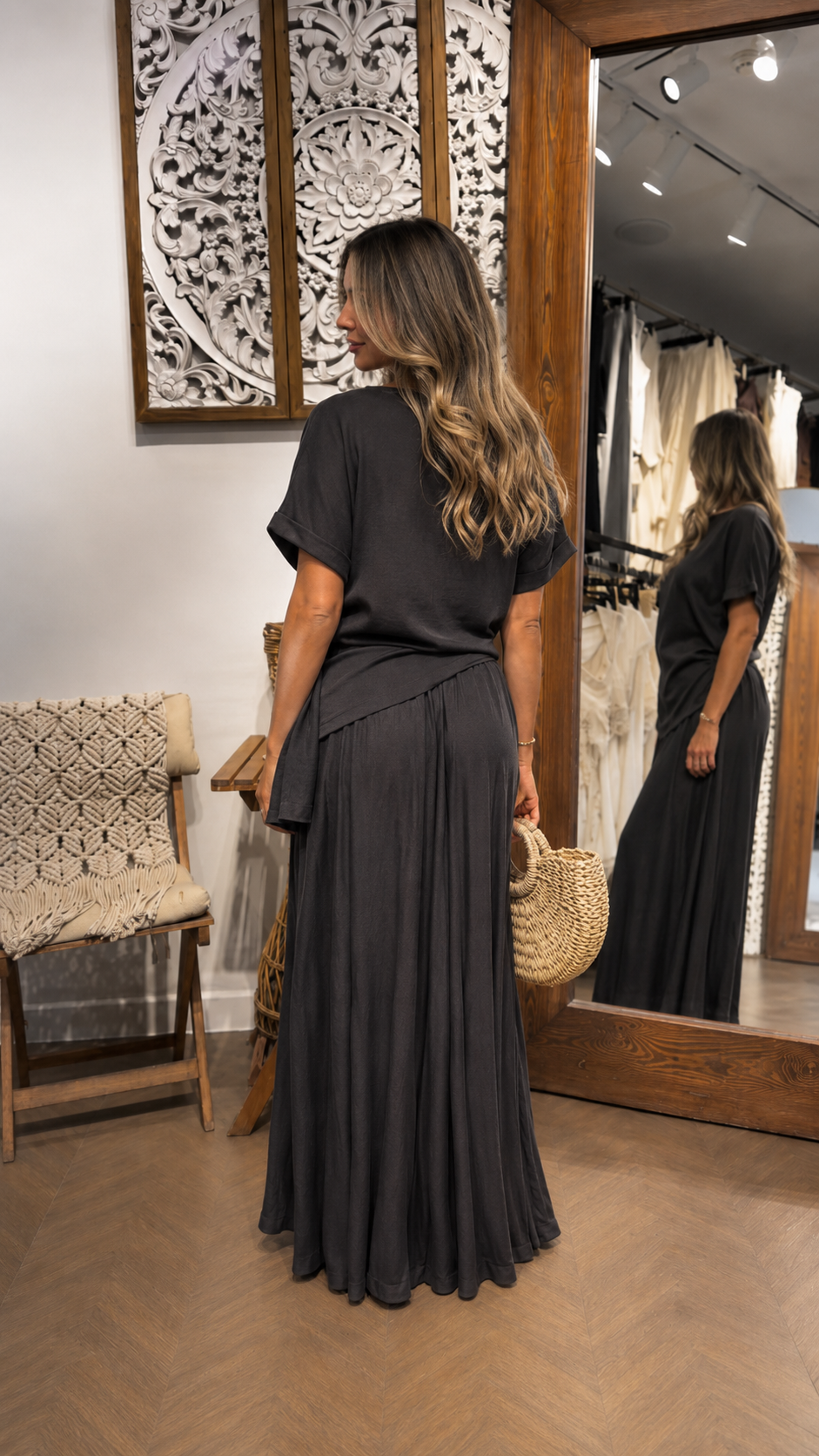 Back view of a charcoal maxi dress showing the relaxed fit and full-length drape