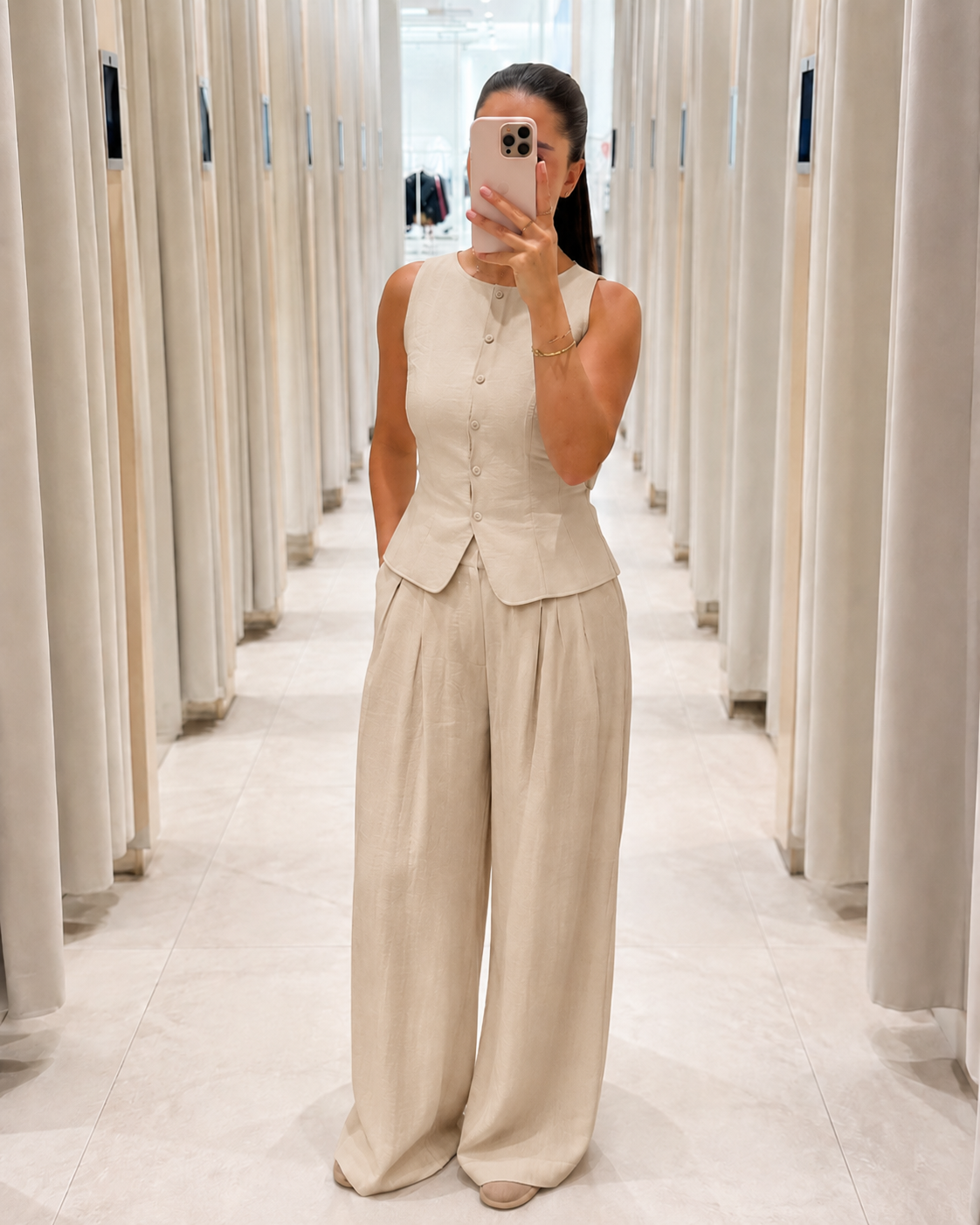 Front view of cream sleeveless peplum top and wide leg pants set