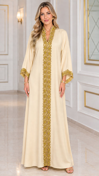 Front view of champagne beige kaftan maxi dress with gold embroidered trim